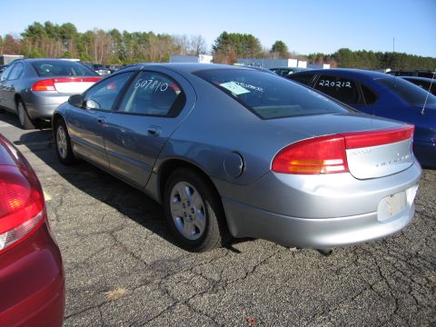 2001 Ford Crown Victoria - Silver sedan in a parking lot with other vehicles visible. Numbers written on the window.
