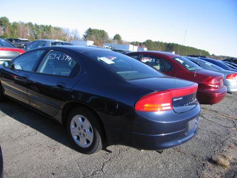 2001 Ford Crown Victoria - A dark blue sedan is parked in an outdoor lot with other vehicles visible.