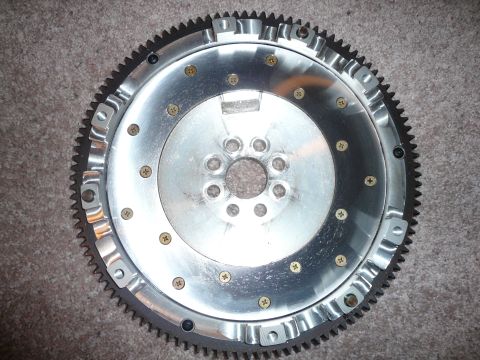 1993 Ford Probe - A close-up view of an aluminum flywheel, a crucial component in a vehicle's drivetrain.
