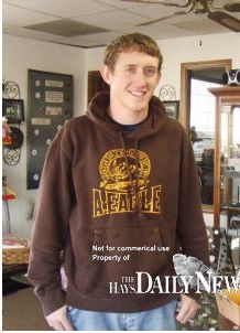 2001 Ford F-150 - Man wearing a brown hoodie with a circular logo and text.