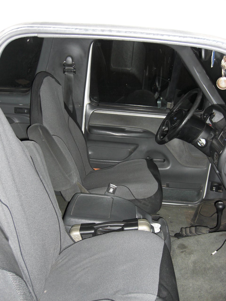 Interior shot of a vehicle showing front seats, dashboard, and steering wheel