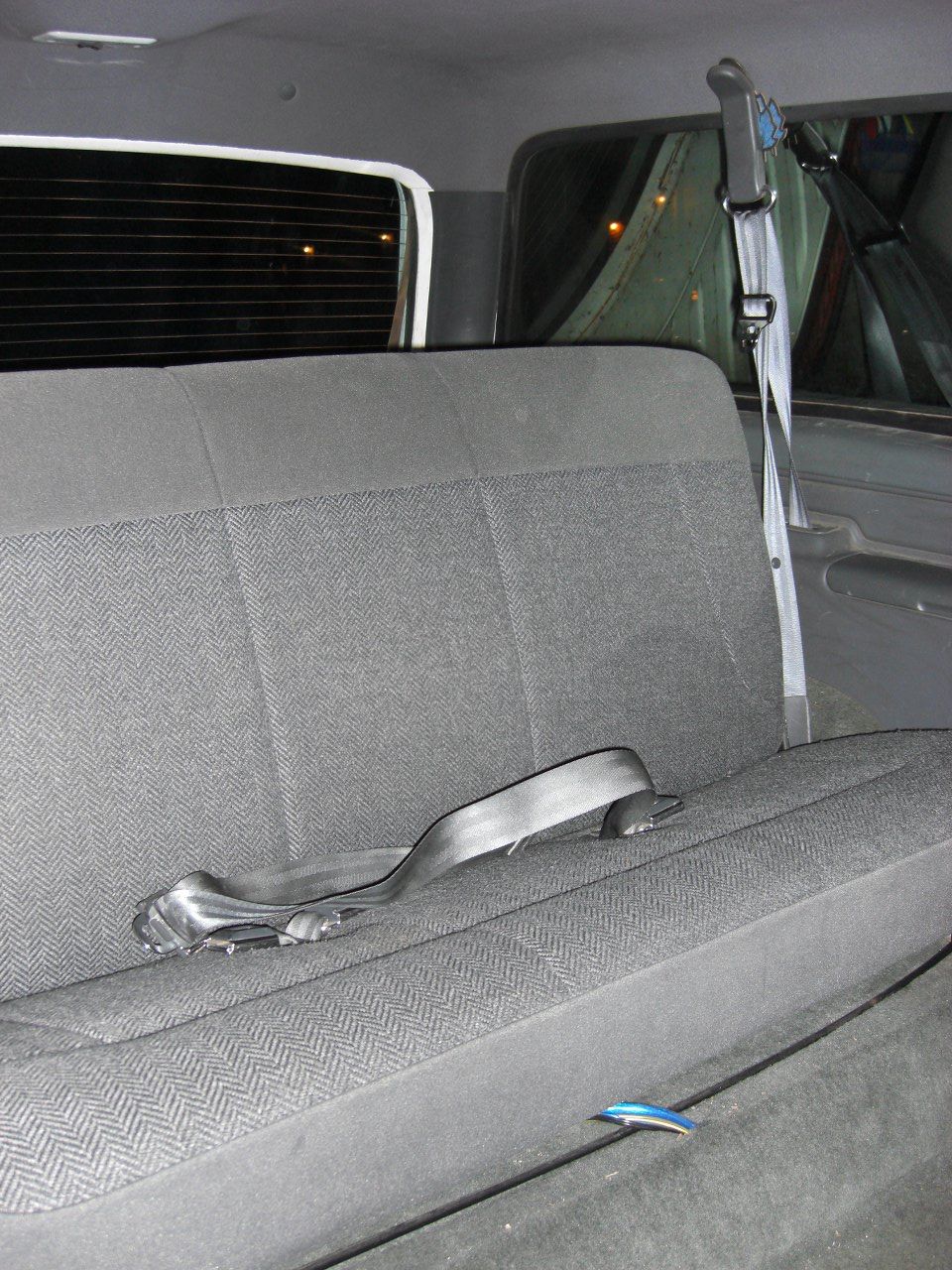 Gray fabric rear bench seat with a black seatbelt in a 1993 Ford Bronco