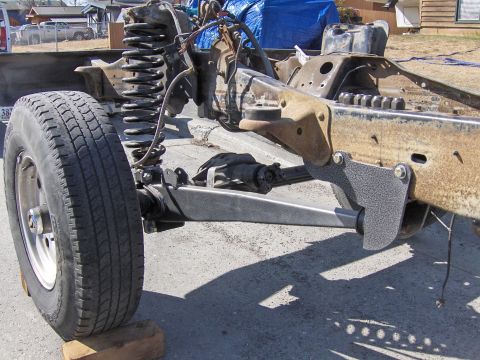 1990 Ford Bronco - This image shows the chassis and suspension components of a vehicle, likely undergoing modification or repair.