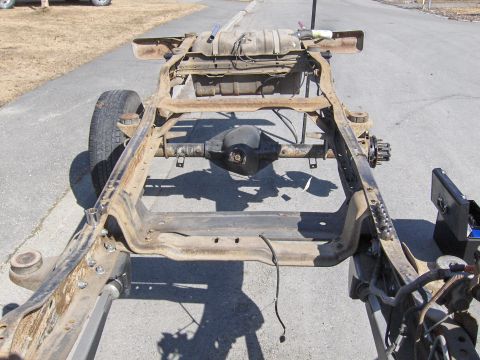1990 Ford Bronco - This image shows the frame of a vehicle, including the rear axle and fuel tank, likely for an axle swap project.