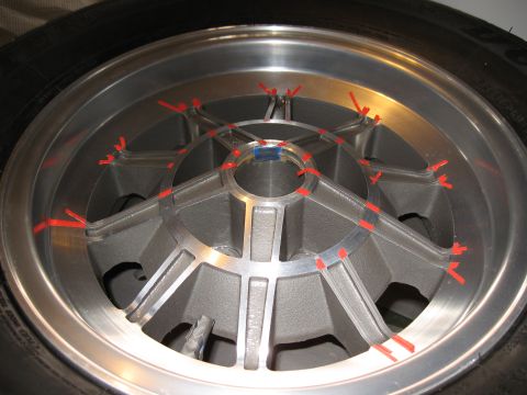 1968 Shelby GT500 - A close-up view of a five-spoke alloy wheel, marked with red tape for measurement or alignment purposes.