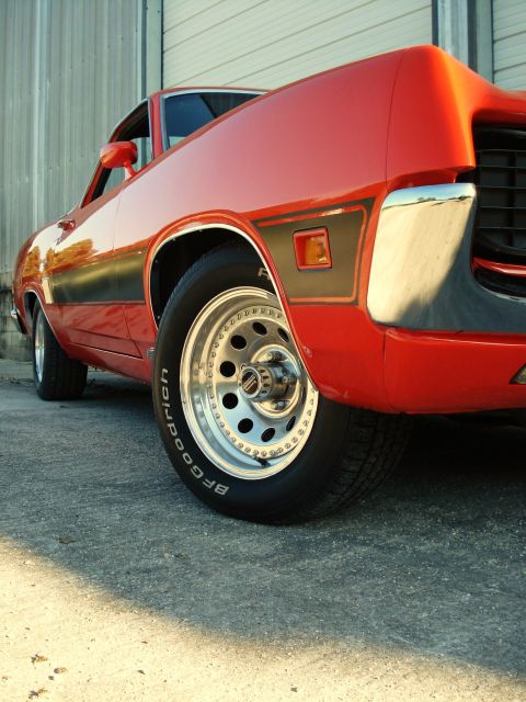 1970 Ford Ranchero - Close-up of the rear quarter panel and wheel of a red 1970 Ford Ranchero GT.