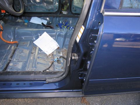 1991 Ford LTD Crown Victoria - The interior of a blue 1991 Ford Crown Victoria LTD is visible with the driver's side door ajar, revealing a bare floor and a document.