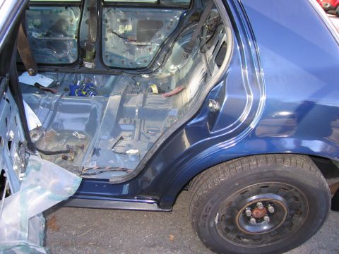 1991 Ford LTD Crown Victoria - Car interior stripped down to the metal frame, revealing wiring and structural components.