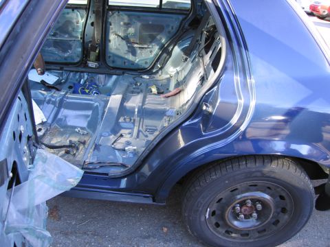 1991 Ford LTD Crown Victoria - The interior of a blue car has been stripped down to its bare metal frame.