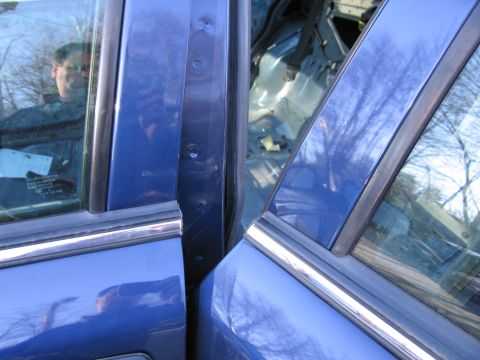 1991 Ford LTD Crown Victoria - Open doors reveal the empty interior of a blue car, with visible door jamb details.