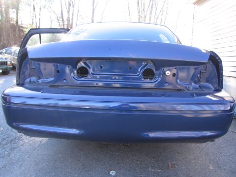 1991 Ford LTD Crown Victoria - The rear of a blue sedan is shown with the trunk open and taillights removed.