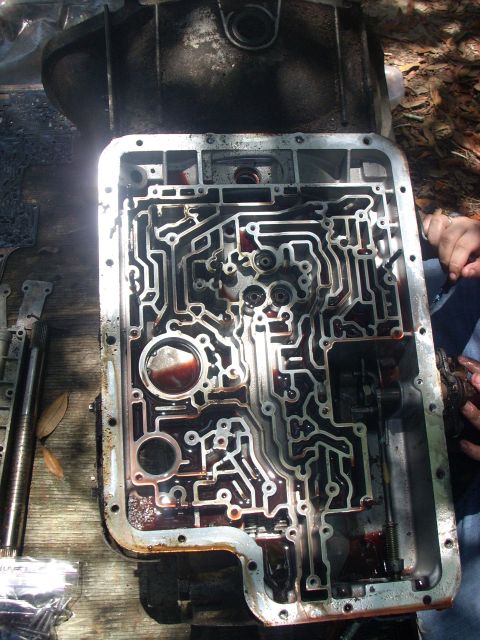 1992 Ford Bronco - when the seperator plate is off you will see 8-10 balls, 1 steel ball w/ spring, a couple of filters, the OD servo cover, and 3 bolts holdi…
