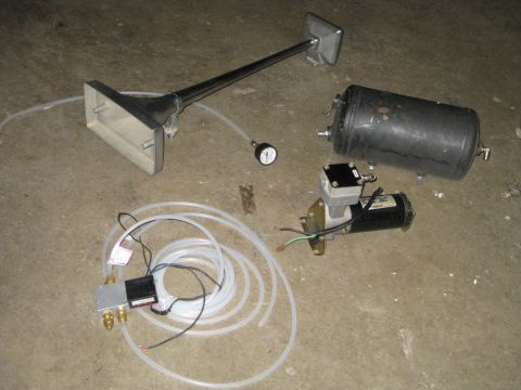 1995 Ford Bronco - Air horn and compressor kit components are displayed on a concrete surface.