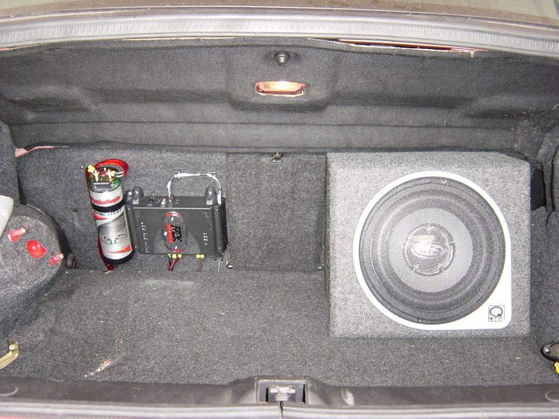 Carpeted trunk with Rockford Fosgate subwoofer in box, amplifier, and capacitor installed