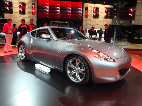 1993 Ford Taurus - Silver Nissan 370Z sports coupe on display at an auto show.