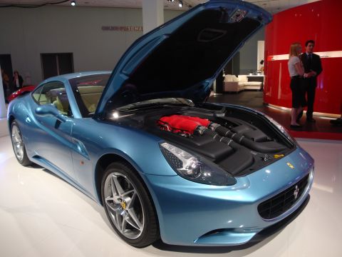 1993 Ford Taurus - A blue Ferrari California is displayed with its hood open, revealing the engine.