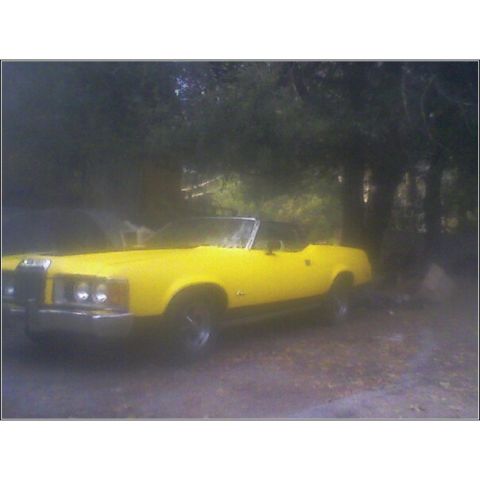 1973 Mercury Cougar - Yellow 1973 Mercury Cougar convertible parked in a wooded area.