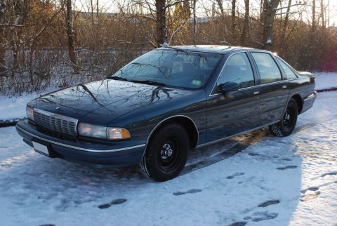 1998 Ford Crown Victoria - This 1996 Chevrolet Caprice sedan is seen in a snowy outdoor setting with trees visible.