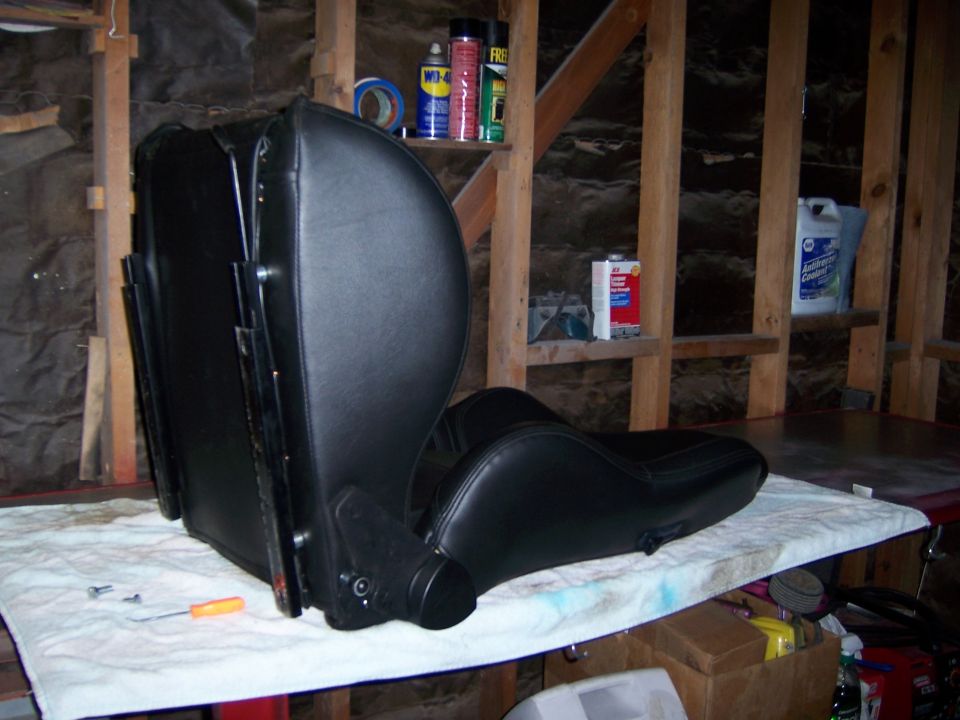 black car seat on a table with tools nearby