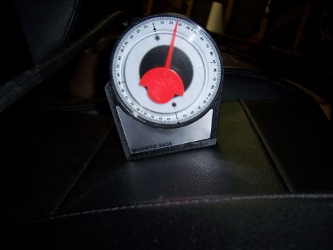 1991 Ford Bronco - Angle gauge with magnetic base sits on a black leather seat.