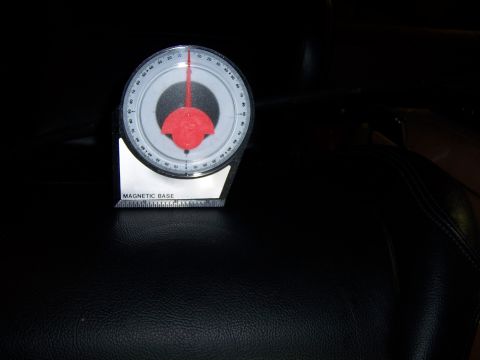 1991 Ford Bronco - A magnetic base inclinometer is shown on a dark, textured surface, possibly a car seat.