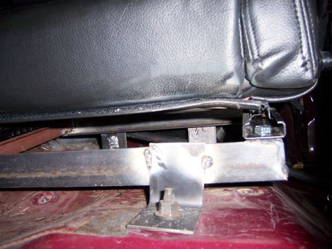 1991 Ford Bronco - Custom seat brackets are bolted to the floor of a vehicle.