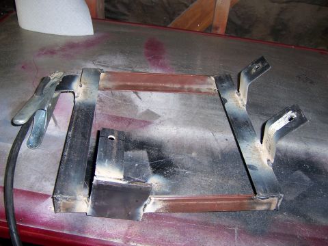 1991 Ford Bronco - Custom metal brackets welded together, with a welding clamp attached.