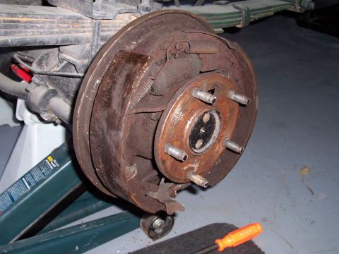 1978 Ford Bronco - Close-up of a corroded vehicle brake drum assembly, showing wear and tear.