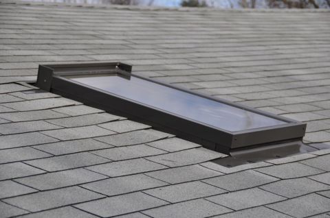 1996 Ford Bronco - A close-up view of a newly installed skylight on a residential roof.