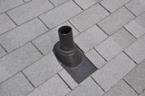 1996 Ford Bronco - A roof vent pipe is installed on gray asphalt shingles, likely for plumbing or ventilation.
