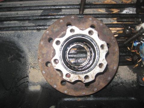 1988 Ford Bronco - A rusty wheel hub assembly with bearings is shown, likely removed from a vehicle for maintenance or repair.