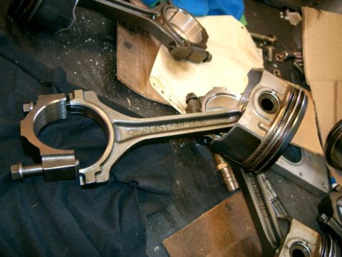 2007 Ford Mustang - Close-up of engine connecting rods and pistons, some with part numbers visible.
