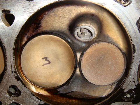 2007 Ford Mustang - Close-up view of an engine cylinder head, showing two valve seats and carbon buildup.