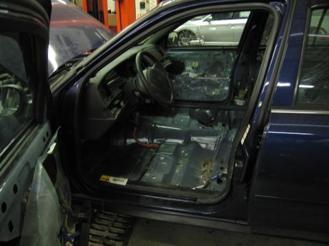 1991 Ford LTD Crown Victoria - Interior view of a 1991 Ford Crown Victoria LTD undergoing repairs, with door panels removed.