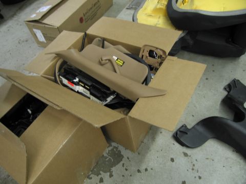 1991 Ford LTD Crown Victoria - Various car interior parts, including trim and dashboard components, are organized in cardboard boxes.