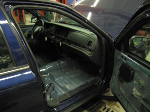 1991 Ford LTD Crown Victoria - Interior view of a 1991 Ford Crown Victoria LTD with seats removed, revealing the bare floor.