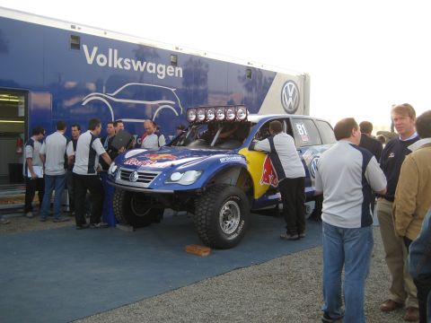 1996 Ford Bronco - A group of people gather around a modified Volkswagen Touareg race truck with Red Bull sponsorship.