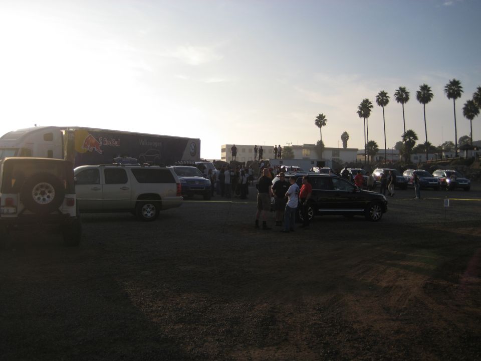 Truck with Red Bull livery and several parked vehicles