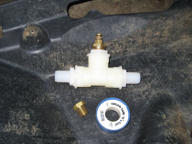 Plastic T-fitting with brass valve and Teflon tape