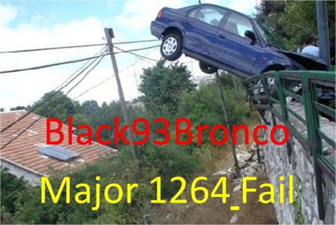 1989 Ford Bronco - A blue sedan is stuck on a guardrail, with its front end hanging over an embankment.