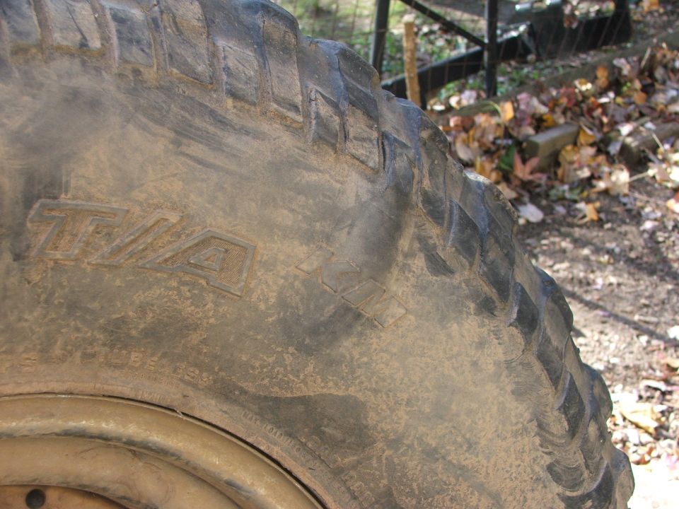 Close-up of a muddy tire with T/A markings on the sidewall