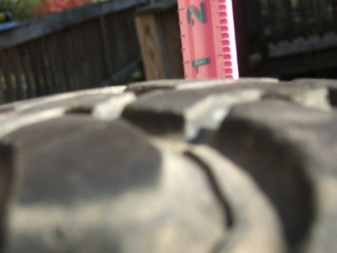 1996 Ford Bronco - A ruler is used to measure the tread depth of a tire.