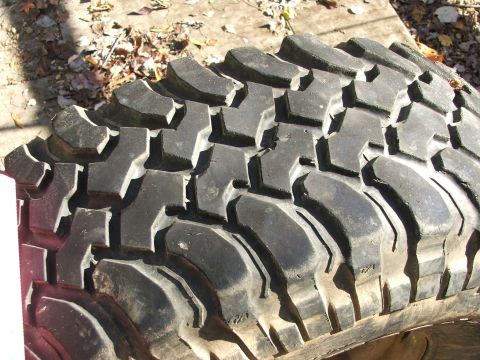 1996 Ford Bronco - A tire with aggressive tread pattern is shown, suggesting off-road capability.