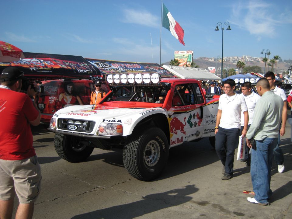 Off-road race truck with Red Bull livery and multiple lights on top