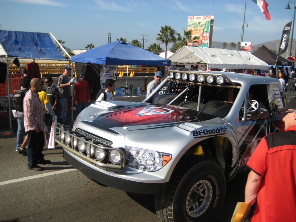 Silver off-road truck with BFGoodrich tires and a light bar on the roof