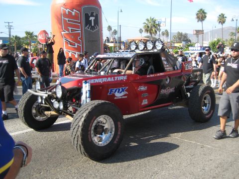 1996 Ford Bronco - A custom-built off-road buggy is displayed with a large inflatable can in the background.