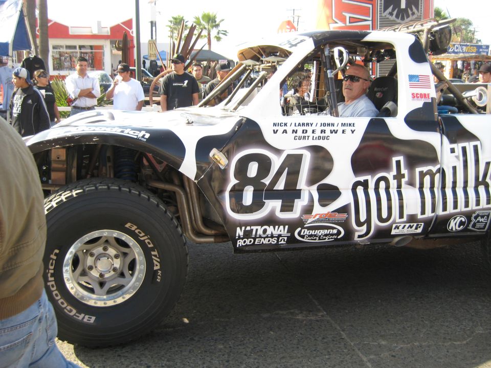 Off-road race truck with black and white cow print, number 84, and 'got milk' livery