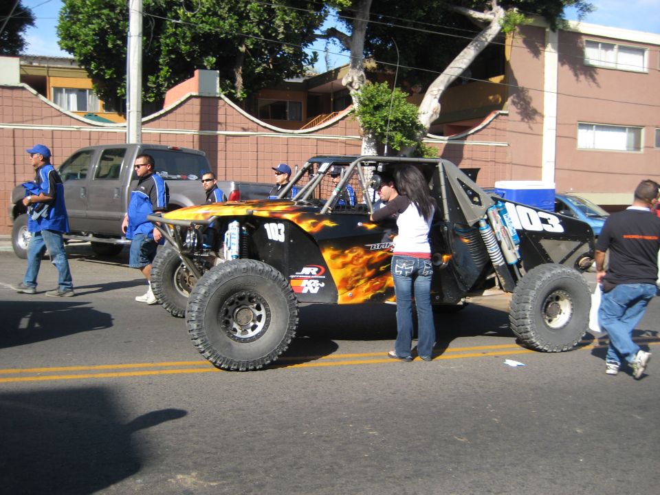 Off-road buggy with flame decals and number 103, seen from the side