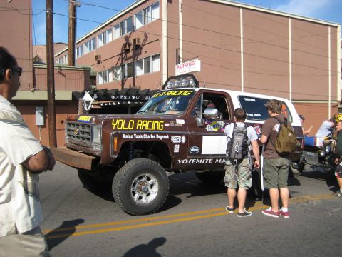 1996 Ford Bronco - This lifted SUV, adorned with 'YOLO RACING' decals and auxiliary lights, appears to be a participant in a desert race event.