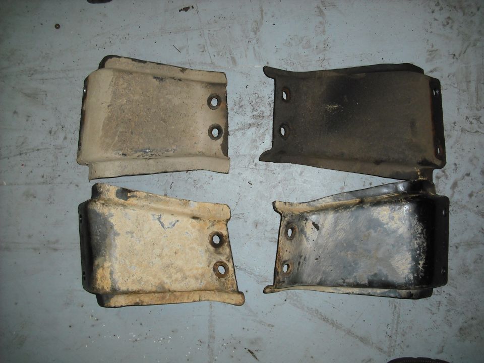 on top the original crossmember braces and below the new ones